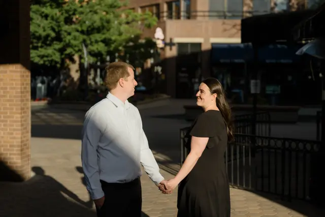 Holding hands in a pool of golden light
