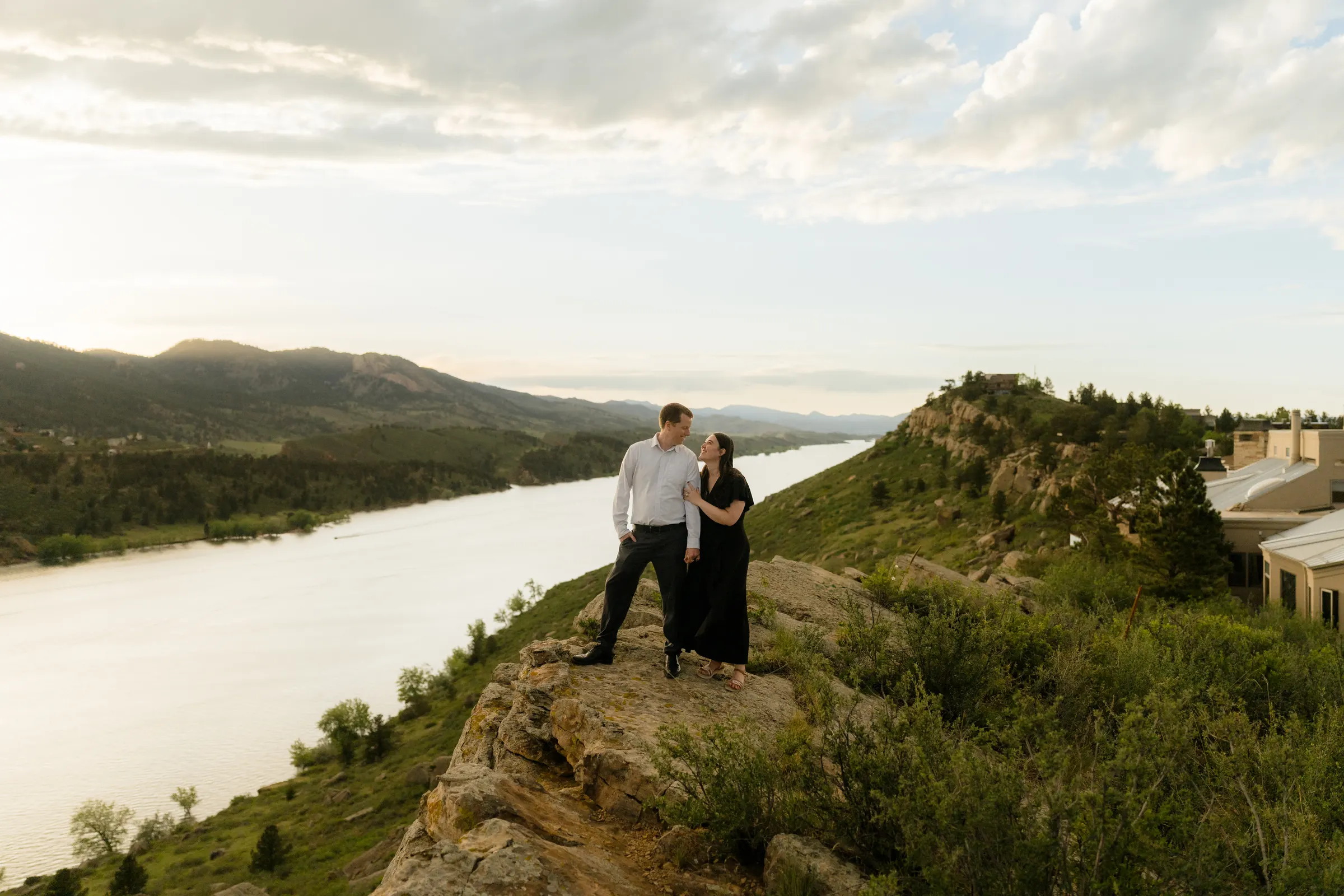 Brianna and Evan standing on a rock outcrop above Horsetooth Reservoir