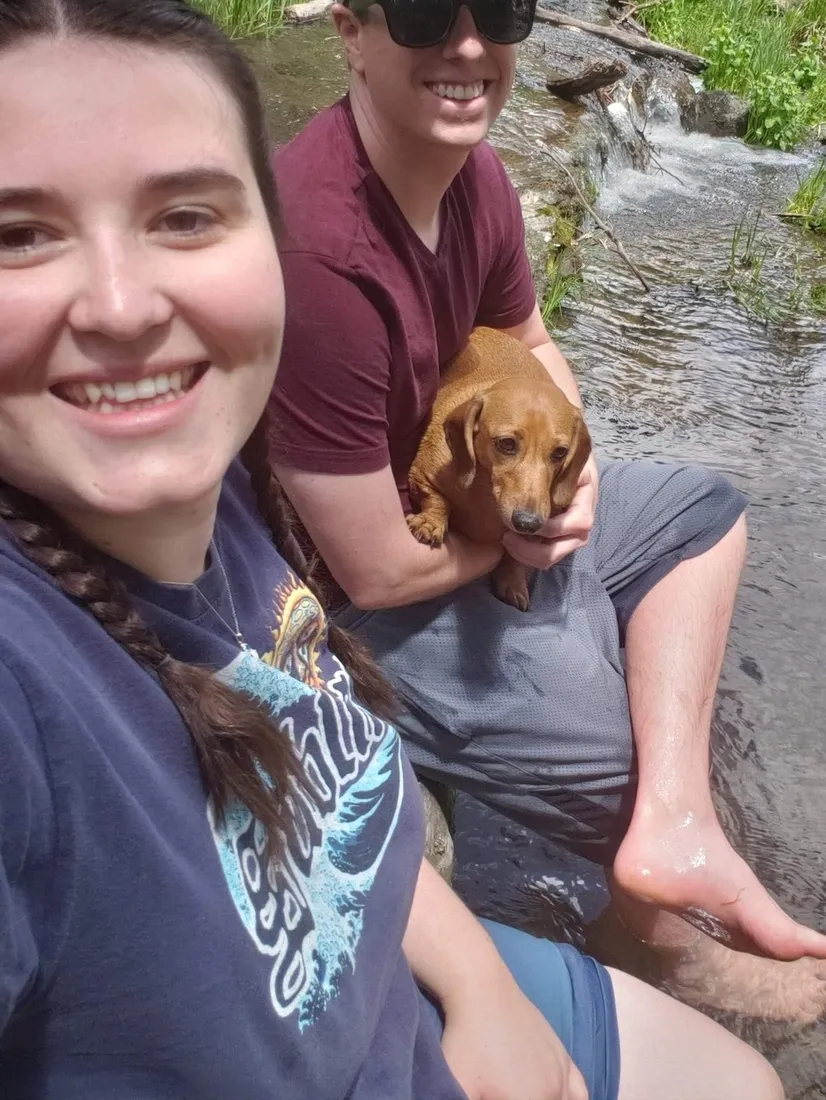 Brianna and Evan holding their new dachshund puppy